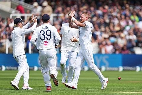 England's captain Ben Stokes, right, celebrates with teammates after the dismissal of New Zealand's Devon Conway during the fourth day of the Test.