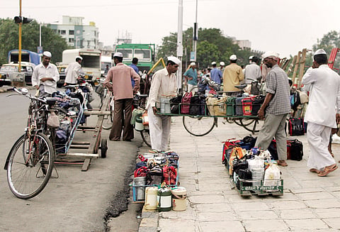 In this photo from July 13, 2006, Dabbawalas load tiffin boxes onto their bicycles before delivering them to office-goers in Mumbai.