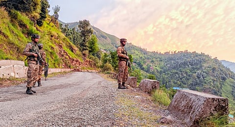 Security personnel stand guard in the Gambhir Mughalan-Dori Maal area of Rajouri district, Jammu and Kashmir.