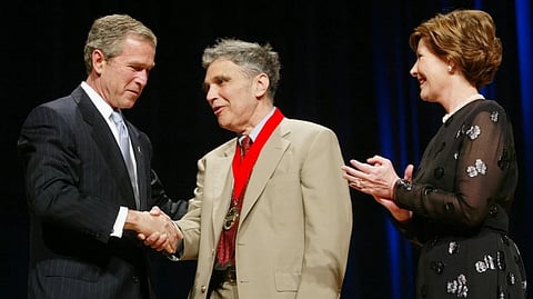 President Bush, left, shakes hands with Robert Coles, center, a child psychologist, researcher and professor of psychiatry from Cambridge, Mass., as first lady Laura Bush looks on during the National Endowment for the Arts Awards ceremony at Constitution Hall, April 22, 2002, in Washington.
