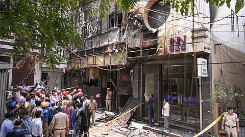 Police and firefighters at the site after a fire broke out at a bed-and-breakfast in a five-storey building in south Delhi's Malviya Nagar area, Wednesday, June 3, 2026.