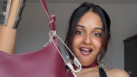 Dhrithi Ganesan styles a metallic safety pin clip as a chic bag accessory and a hair clip