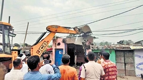 The demolition drive underway at Meenapada slum in Rourkela on Monday.