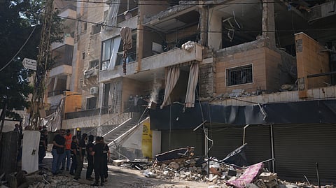 Lebanese security officers gather at the site where an Israeli airstrike hit a building in Dahiyeh, Beirut's southern suburb, Lebanon, Sunday, June 7, 2026.