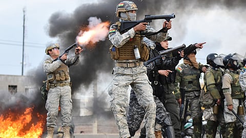Police fire tear gas at anti-government protesters blocking a highway in Vinto, Bolivia, Monday, June 8, 2026.