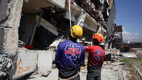 Rescuers inspect a damaged building following an earhtquake in General Santos, Philippines Tuesday, June 9, 2026