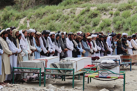 Mourners pray during a funeral for victims, including children, of airstrikes that Taliban officials said were carried out by Pakistan, in Mana, a village in Afghanistan's Khost province, Wednesday, June 10, 2026.