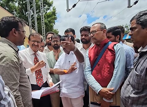 Bengaluru Rural MP Dr CN Manjunath interacts with rail commuters at Anekal
Road railway station on Tuesday.