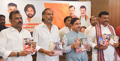 Union Minister Prahlad Joshi, along with AP ministers Ravi Kumar & Satya Prasad and AP BJP chief PVN Madhav, releasing a book on PM Modi’s 12-yr rule