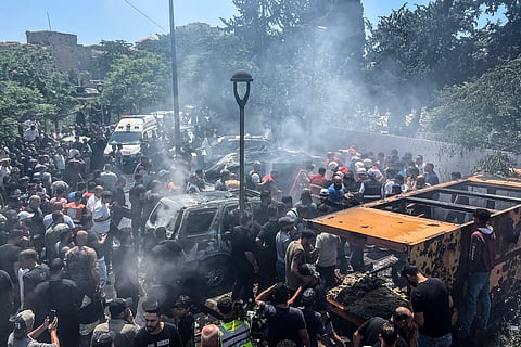 First responders and residents gather at the site of an Israeli airstrike that hit a car in Sidon on June 10, 2026.