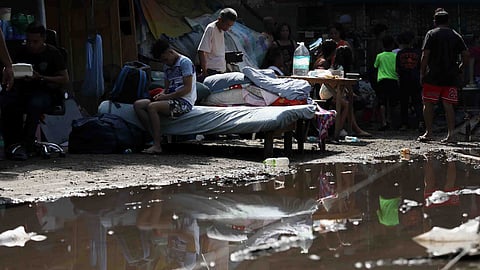 Residents gather their belongings as they evacuate from their damaged homes in General Santos, southern Philippines, Thursday, June 11, 2026, following Monday's powerful earthquake.