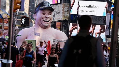 A large inflatable figure depicting Elon Musk stands in Times Square in New York on Thursday