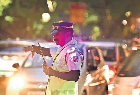 A police officer managing the traffic near Subhash Park wearing a shoulder blinker