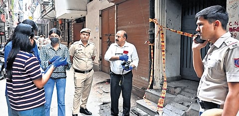 Forensic, police team near 5-storey building where fire took place on Friday