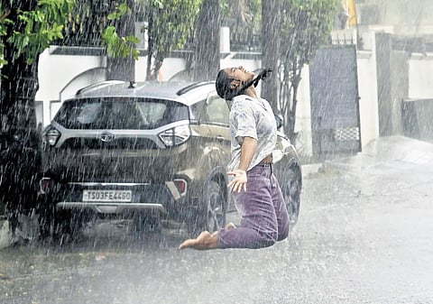A girl jumps in delight as it rains in Karimnagar on Friday