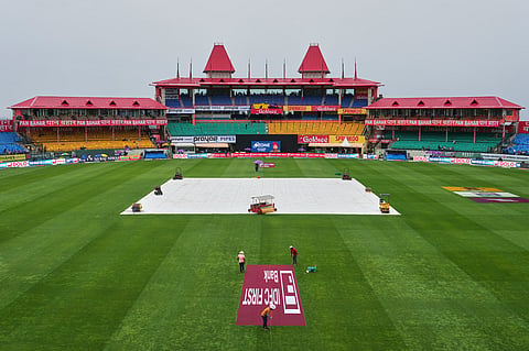 Rain covers are on at the Himachal Pradesh Cricket Association (HPCA) stadium against the backdrop of the Dhauladhar range of the Himalayas ahead of the first ODI cricket match between Afghanistan and India in Dharamshala, Saturday, June 13, 2026.