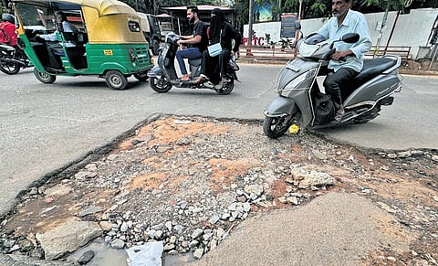 A damaged road poses a danger to motorists near Parachute Regiment at JC Nagar. CM DK Shivakumar recently announced Rs 2,000 crore grant for repairing all city roads