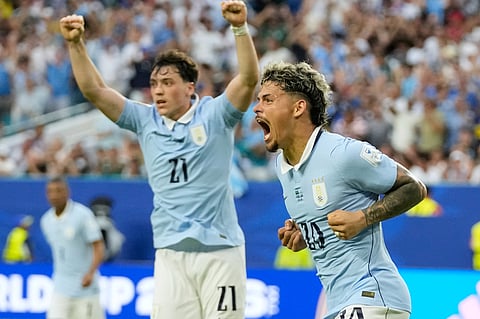 Uruguay's Maxi Araujo celebrates scoring his side's opening goal against Saudi Arabia during a World Cup.
