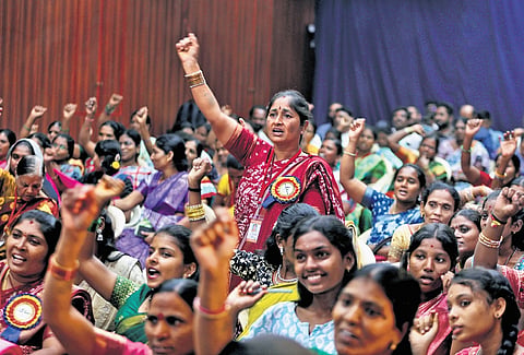 Domestic workers raise slogans during a programme at a private school in Abids, Hyderabad, on Tuesday