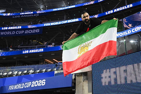 An Iranian fan shows a pre-revolutionary Iranian flag after the 2026 World Cup Group G football match between Iran and New Zealand.