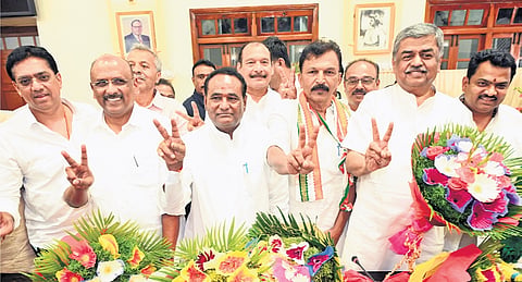Victorious candidates of the Congress pose for the shutterbugs after the results of the Council polls were declared, in Vidhana Soudha on Thursday