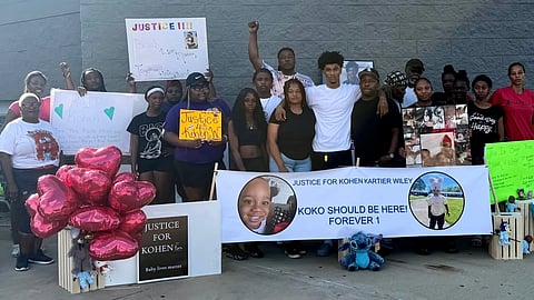 In this photo provided by Marquell Bridges, a group of mourners attend a makeshift memorial for 1-year old Kohen Wiley, outside the Walmart where the boy was shot by police in Senatobia, Miss., on Wednesday, June 17, 2026.
