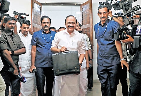 Chief Minister V D Satheesan coming out of Cantonment House carrying the printed copy of the state budget before proceeding to the assembly for its presentation, accompanied by officials and security personnel