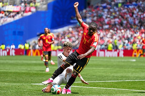 Belgium's Jeremy Doku, front, and Egypt's Emam Ashour fight for the ball during the World Cup Group G soccer match in Seattle, Monday, June 15, 2026.