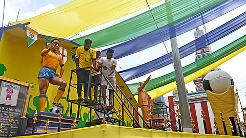 The entrance to ‘Little Brazil’ adorned with a 6-foot-tall FIFA World Cup trophy replica