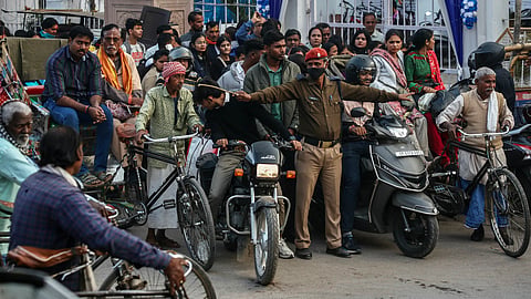 A traffic policeman regulates the commuters unceasingly wait amid a traffic jam on a road in Varanasi, Uttar Pradesh