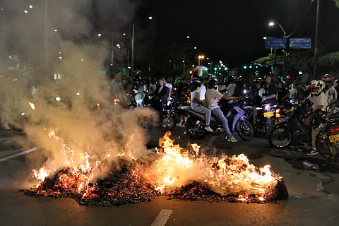 Supporters of presidential candidate Ivan Cepeda of the ruling Historic Pact coalition burn trash after election results showed him trailing in the runoff election in Cali, Colombia, Sunday, June 21, 2026.