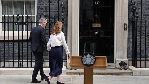 Britain PM Keir Starmer and wife Victoria walk back to 10 Downing Street after addressing the media announcing his resignation on Monday in London