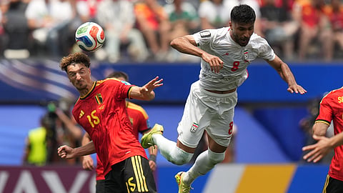 Belgium's Thomas Meunier, left, heads the ball past Iran's Mohammad Mohebbi during the World Cup Group G soccer match between Belgium and Iran in Inglewood, Calif., near Los Angeles, Sunday, June 21, 2026.