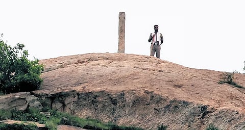 A policeman keeping vigil over the deepathoon, or stone pillar designed to hold lamps, on Thiruparankundram hill near Madurai.
