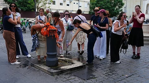 People cool off at a fountain in Rome, Tuesday, June 23, 2026.