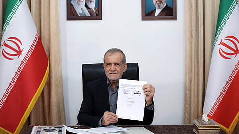 In this photo from June 18, 2026, Iranian President Masoud Pezeshkian displays a memorandum of understanding signed with US President Donald Trump aimed at ending the war and launching negotiations on a broader agreement in Tehran.