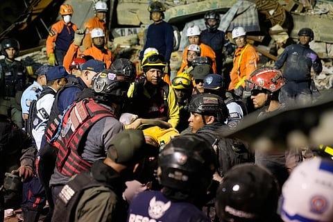 Rescue workers search through the rubble of a collapsed building after earthquake in Caracas, Venezuela, Wednesday, June 24, 2026.