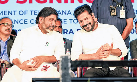 Chief Minister A Revanth Reddy shares a lighter moment with Deputy Chief Minister Mallu Bhatti Vikramarka during the MoU signing ceremony in Hyderabad on Thursday