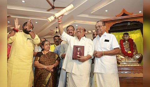 SNDP Yogam general secretary Vellappally Natesan raises the Padma Bhushan citation and memento during the reception accorded to him at Ernakulam Town Hall on Wednesday.