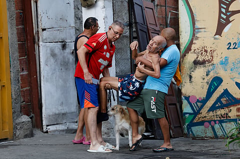 Neighbors helps a man evacuate his damaged home after an earthquake in Caracas, Venezuela, Wednesday, June 24, 2026.