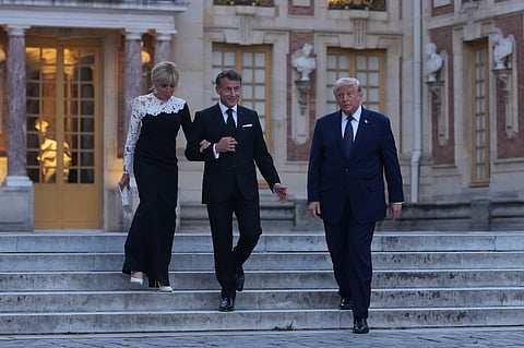 U.S. President Donald Trump is greeted by French President Emmanuel Macron and first lady Brigitte Macron at the Palace of Versailles, Wednesday, June 17, 2026, in Versailles, France.