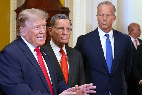President Donald Trump speaks with reporters as Sen. John Barrasso, R-Wyo., and Senate Majority Leader John Thune, R-S.D., listen on Capitol Hill, Wednesday, June 24, 2026, in Washington.