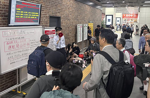 A station clerk of the East Japan Railway Co., provides an update about train services which were suspended due to an earthquake at JR Morioka station in Morioka, northern Japan, Thursday, June 25, 2026.