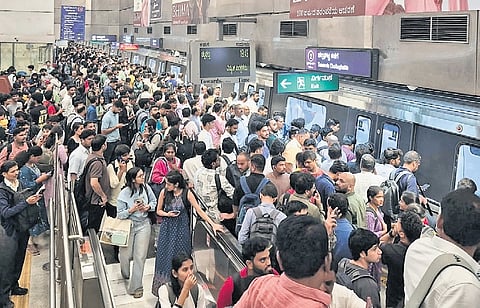 Passengers wait at Cubbon Park Metro Station for services to resume on Thursday