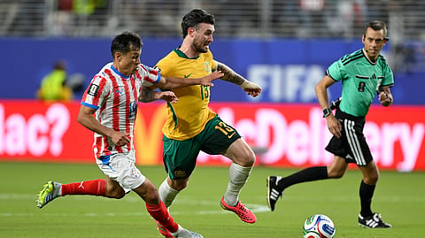 Australia's Aiden O'Neill (13) battles for the ball with Paraguay's Andres Cubas (14) during the World Cup Group D soccer match between Paraguay and Australia in Santa Clara, Calif., near San Francisco, Thursday, June 25, 2026.