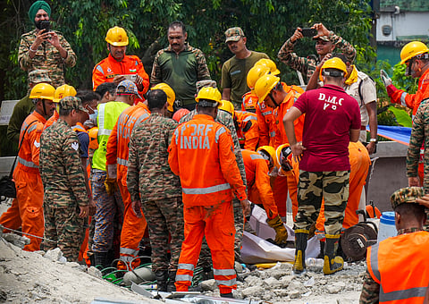 NDRF and Army officials recover a victim's mortal remains during a rescue operation after an under-construction warehouse collapsed on Wednesday, leaving ten people dead and several others injured, in Kolkata's Taratala area, Thursday, June 25, 2026.