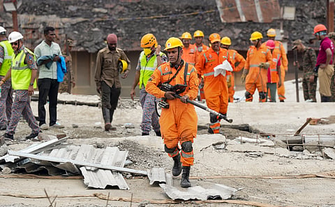 A NDRF official uses a victim search camera on the third day of a search operation after an under-construction warehouse collapsed on Wednesday, leaving several injured and dead, in Kolkata's Taratala area, Friday, June 26, 2026.