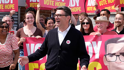 Labour candidate Andy Burnham gestures, surrounded by supporters at the Stubshaw Cross Community and Sports Club as voting is underway in the Makerfield by-election, in Ashton-in-Makerfield, England, Thursday, June 18, 2026.