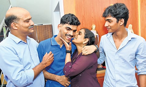 KEAM 2026 state topper Roshan Raju celebrates with his family, after securing first rank in the examination, at his residence in Angamaly on Saturday