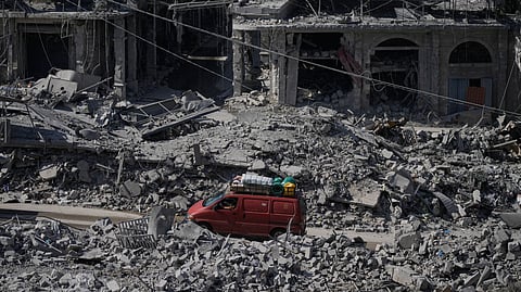 Residents drive past buildings destroyed in previous Israeli airstrikes in the town of Nabatiyeh, southern Lebanon, Wednesday, June 24, 2026, following a ceasefire between Israel and Hezbollah.